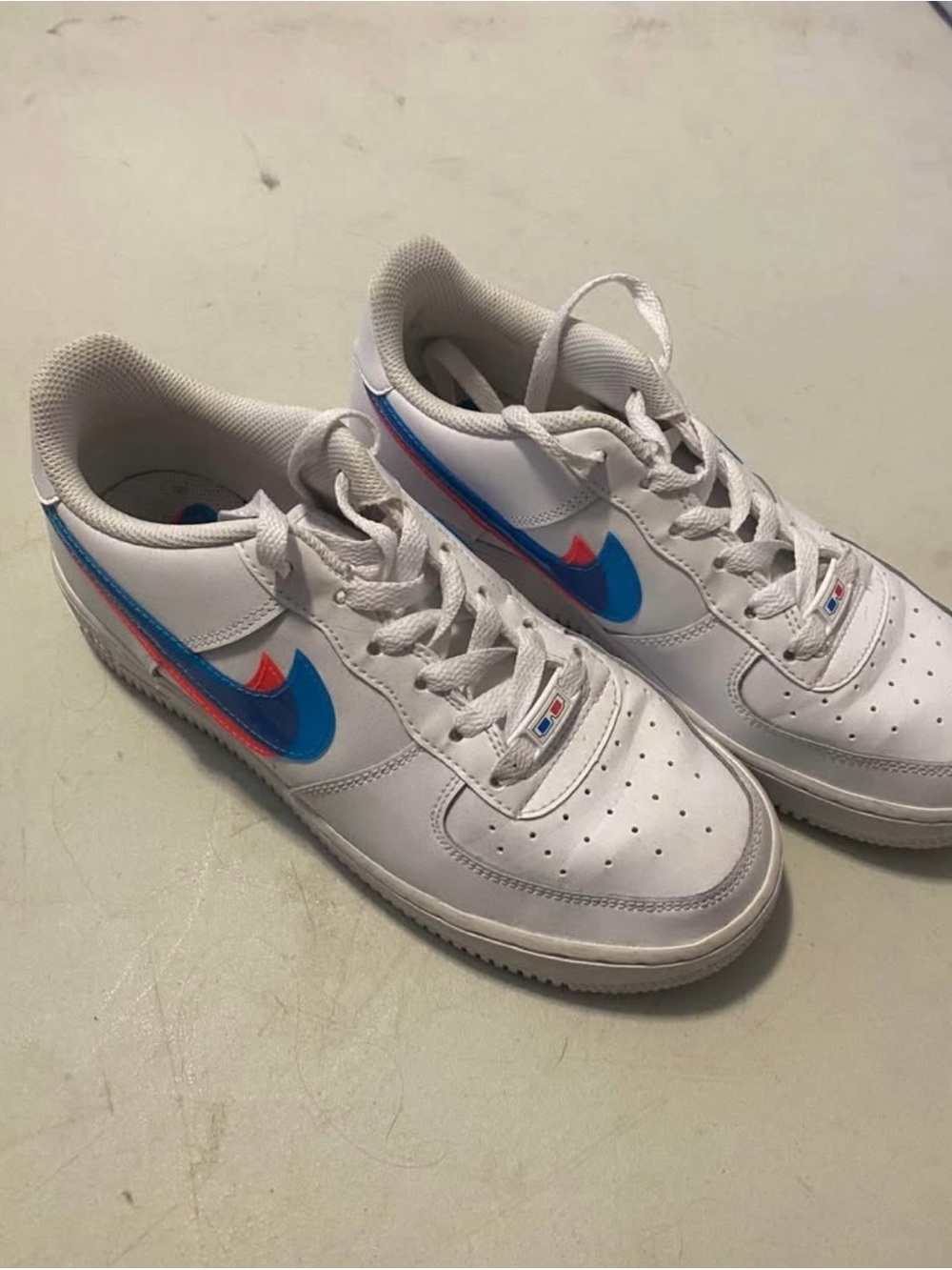Nike Kids White Sneakers with Blue & Red Swoosh Accents